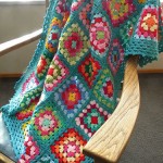 colorful and turquoise border crochet granny square blanket