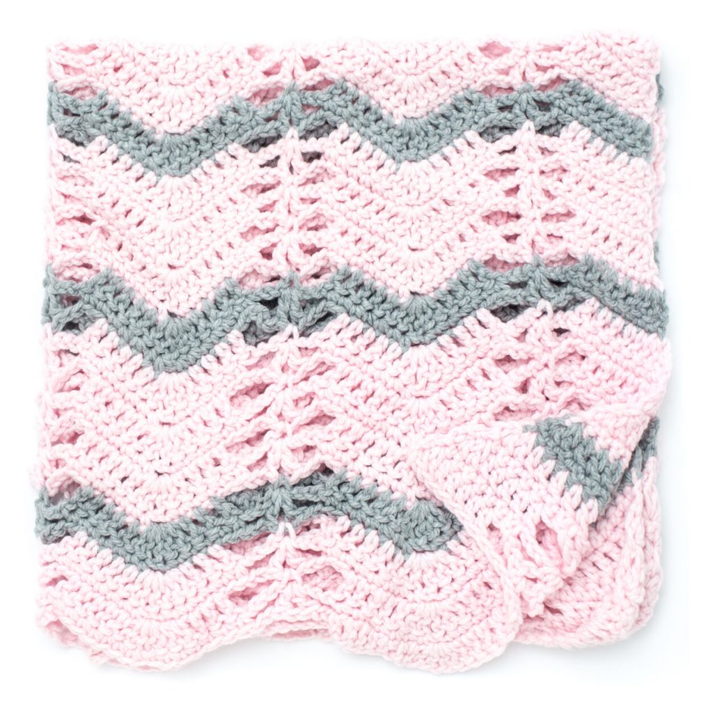 Quick and cosy crochet baby blanket with ripple and lace stitch pattern