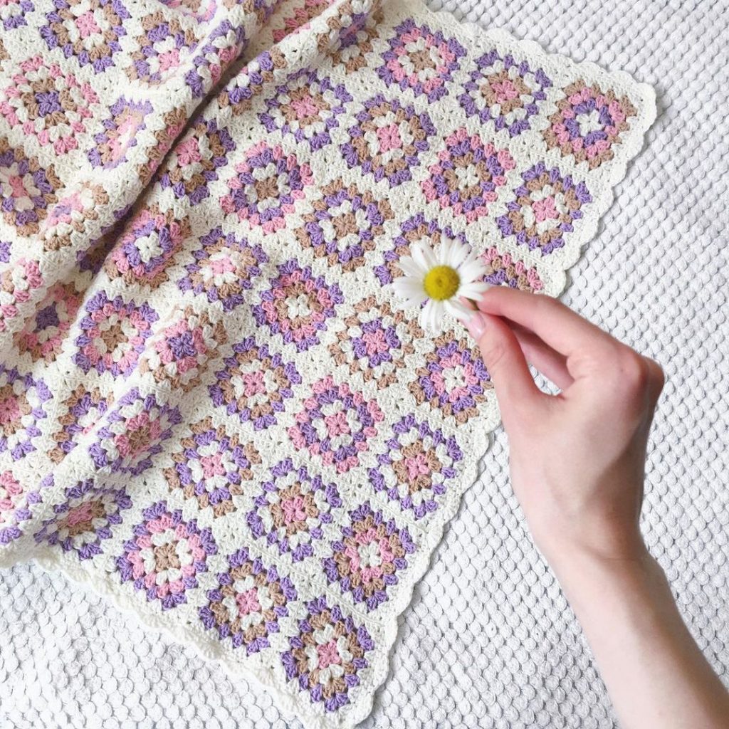 pink, purple, white and brown crochet blanket